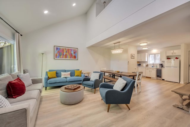130 Cross Country Ln, Tannersville, PA 18372 - living room featuring light wood-type flooring, beverage cooler, recessed lighting, and high vaulted ceiling