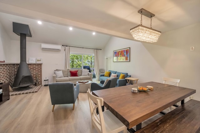 130 Cross Country Ln, Tannersville, PA 18372 - dining space with an AC wall unit, light wood finished floors, a wood stove, lofted ceiling, and a chandelier