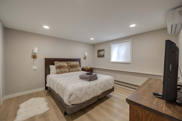 130 Cross Country Ln, Tannersville, PA 18372 - bedroom featuring a baseboard radiator, light wood finished floors, a wall mounted air conditioner, recessed lighting, and baseboards