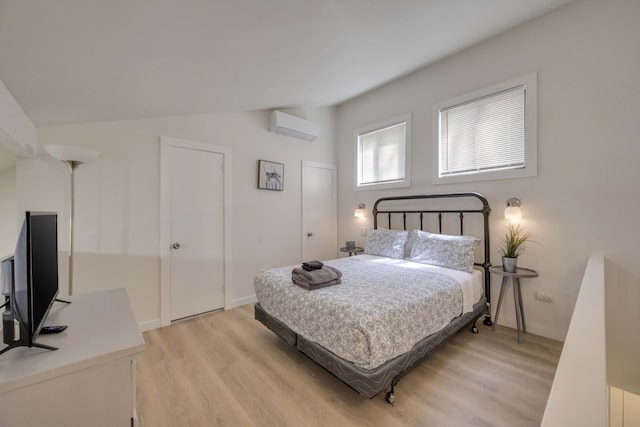 130 Cross Country Ln, Tannersville, PA 18372 - bedroom with a wall mounted AC, light wood-type flooring, and baseboards