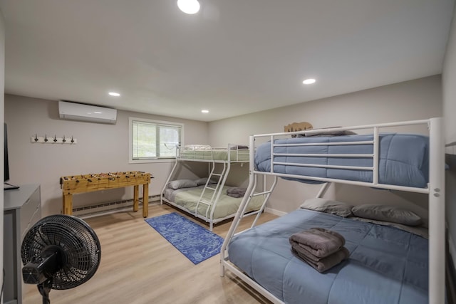 130 Cross Country Ln, Tannersville, PA 18372 - bedroom with a baseboard radiator, a wall unit AC, wood finished floors, recessed lighting, and baseboards