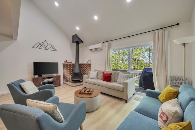 130 Cross Country Ln, Tannersville, PA 18372 - living area with a wall unit AC, a wood stove, light wood-type flooring, recessed lighting, and lofted ceiling