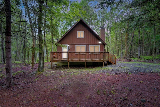 173 Pontiac Path, Pocono Lake, PA 18347 - view of front of house with a chimney, a wooden deck, and a wooded view