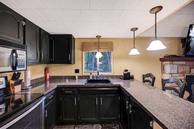 173 Pontiac Path, Pocono Lake, PA 18347 - kitchen with black electric range, dark cabinets, decorative light fixtures, dark countertops, and a peninsula