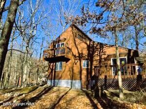 back of house featuring a wooden deck