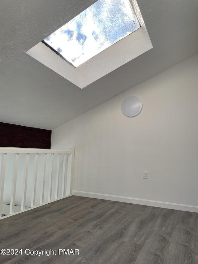 bonus room featuring a skylight, wood finished floors, and baseboards