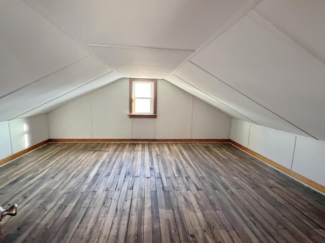 bonus room featuring vaulted ceiling and wood finished floors