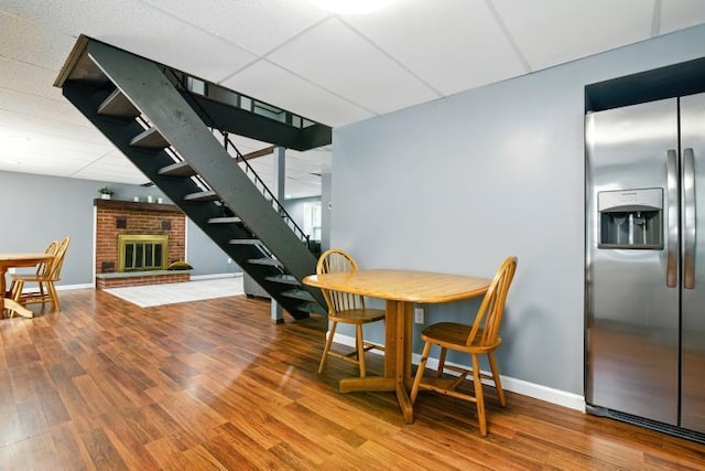 1042 Middleridge Dr, Gouldsboro, PA 18424 - dining space with stairs, wood finished floors, and a brick fireplace