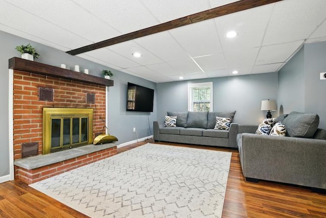 1042 Middleridge Dr, Gouldsboro, PA 18424 - living area with wood finished floors, a brick fireplace, and recessed lighting