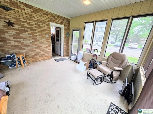 sunroom with brick wall