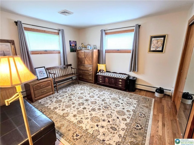 sitting room featuring wood finished floors and a baseboard radiator