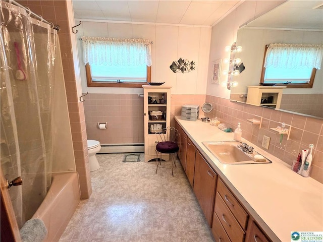 bathroom with ornamental molding, baseboard heating, tile walls, toilet, and vanity