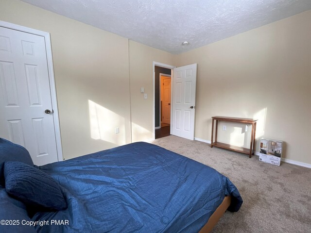 bedroom featuring carpet floors and a textured ceiling