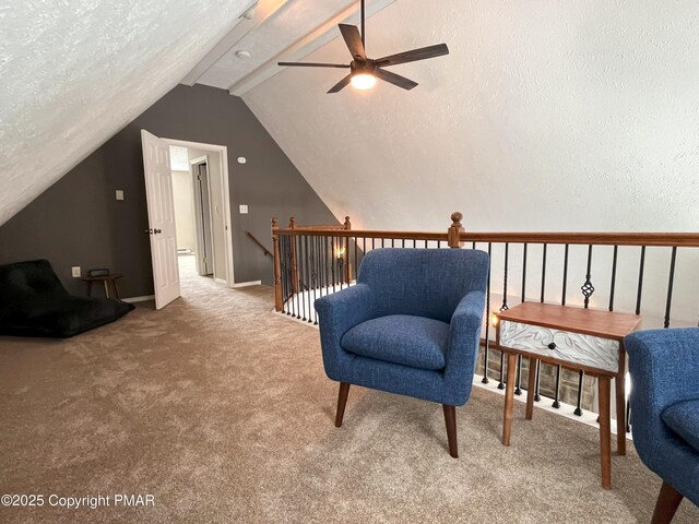 sitting room featuring ceiling fan, lofted ceiling, carpet floors, and a textured ceiling