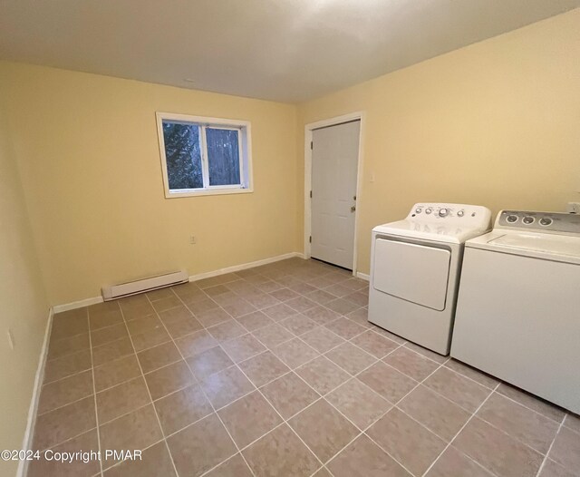 washroom with light tile patterned flooring, independent washer and dryer, and a baseboard heating unit