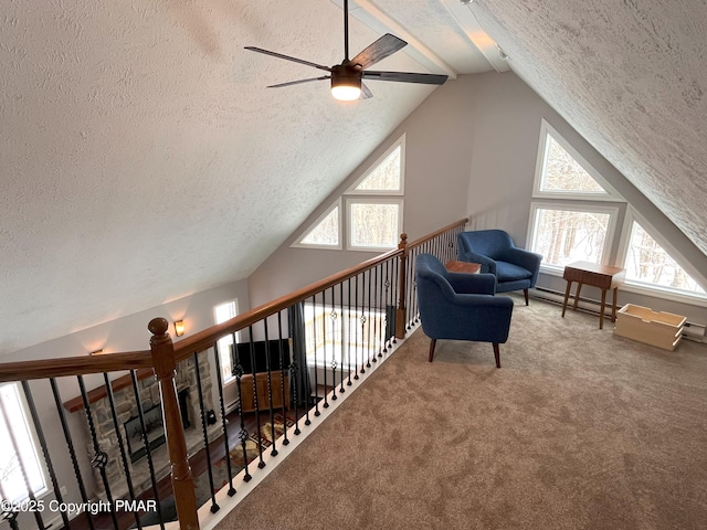 unfurnished room with carpet flooring, vaulted ceiling with beams, and a textured ceiling