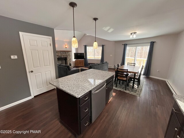 kitchen featuring hanging light fixtures, a healthy amount of sunlight, a center island, and stainless steel dishwasher