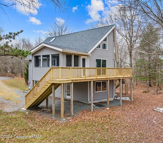 rear view of property featuring a deck