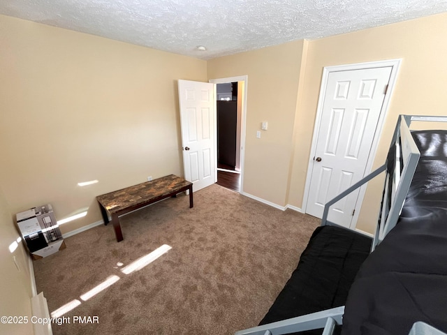 carpeted bedroom featuring a textured ceiling