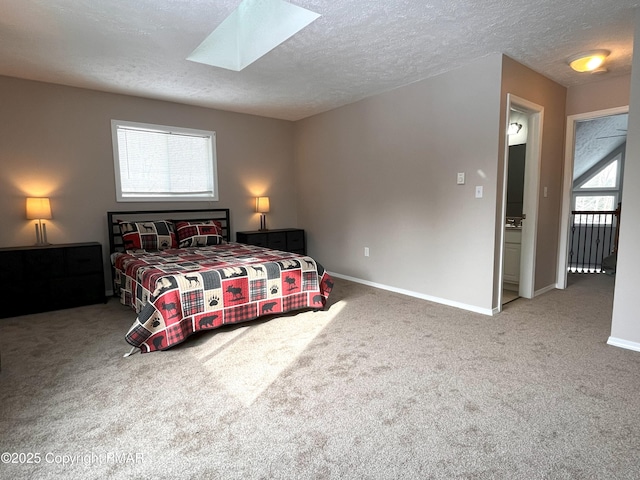 carpeted bedroom featuring a textured ceiling and a skylight