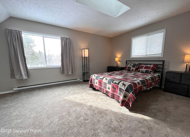 bedroom featuring carpet, vaulted ceiling with skylight, a textured ceiling, and baseboard heating