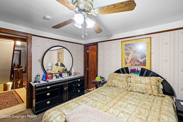 bedroom featuring wallpapered walls and a ceiling fan