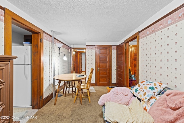 interior space with wallpapered walls and a textured ceiling