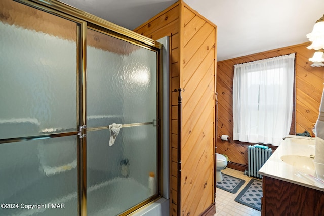 full bathroom with radiator heating unit, wood walls, tile patterned floors, toilet, and a shower with door