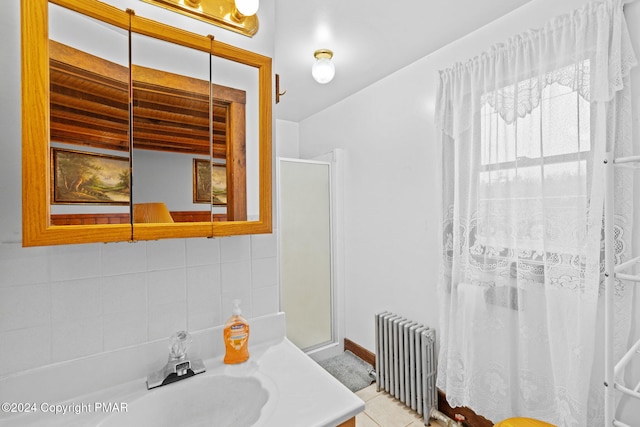 full bath featuring tasteful backsplash, a sink, radiator, and a shower with shower door