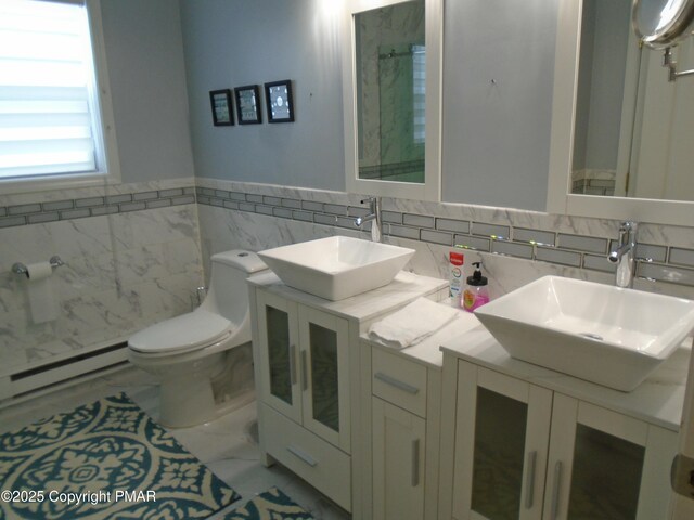 bathroom featuring vanity, baseboard heating, and toilet