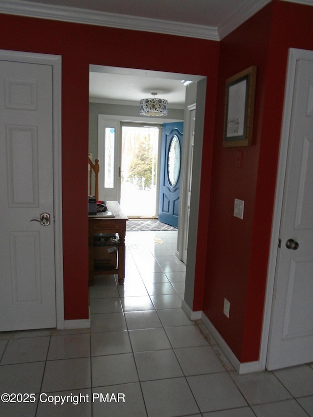 corridor featuring crown molding and light tile patterned floors