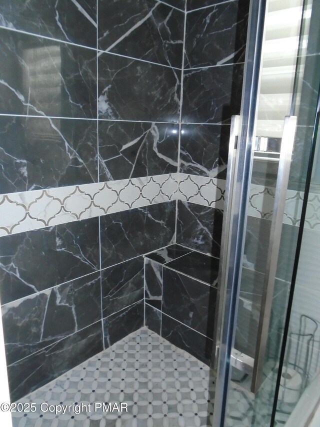 bathroom with a tile shower