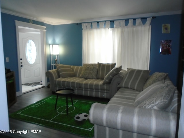 living area featuring plenty of natural light, ornamental molding, and wood finished floors