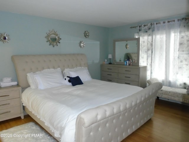 bedroom with wood finished floors