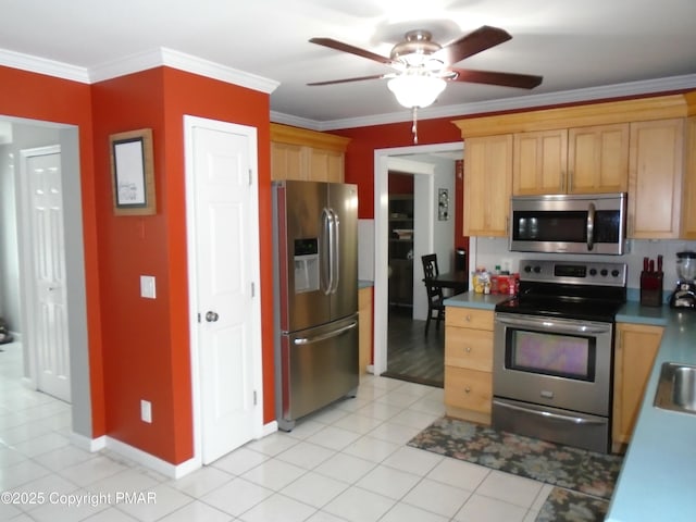 kitchen featuring light tile patterned floors, crown molding, sink, ceiling fan, and appliances with stainless steel finishes