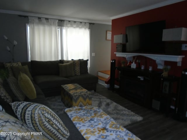 living area featuring ornamental molding and wood finished floors