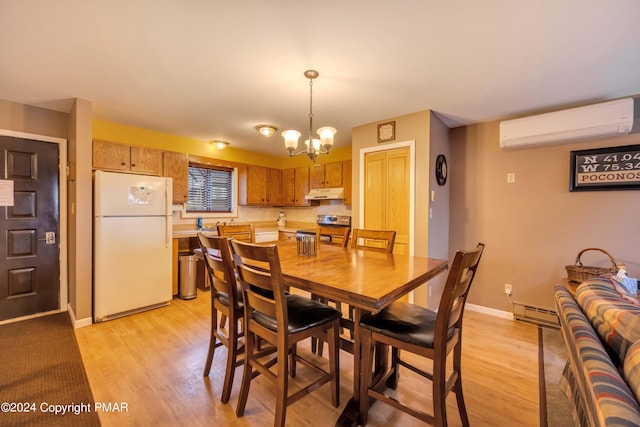 dining area with a wall unit AC, baseboard heating, an inviting chandelier, light wood-type flooring, and baseboards