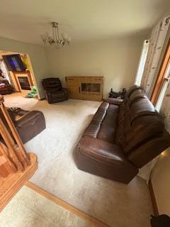 60 Arbutus Ln, East Stroudsburg, PA 18302 - living area featuring a glass covered fireplace and a chandelier