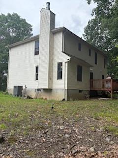 60 Arbutus Ln, East Stroudsburg, PA 18302 - back of property with a wooden deck and a chimney