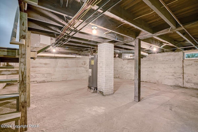 unfinished basement featuring water heater
