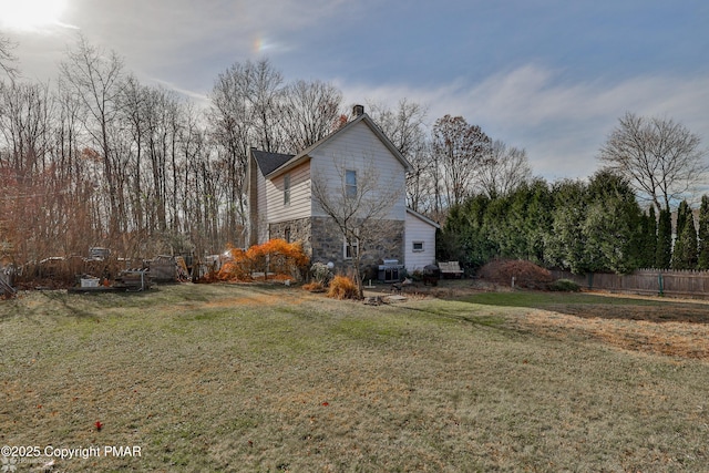 3310 Hazen Ave, Roseto, PA 18013 - view of side of home featuring a yard, stone siding, and fence