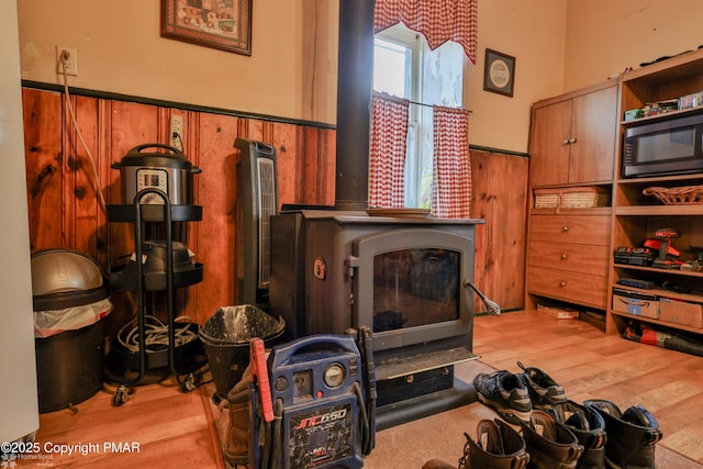 3310 Hazen Ave, Roseto, PA 18013 - interior space featuring wood walls, wainscoting, wood finished floors, and a wood stove