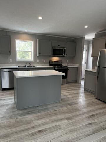132 Spruce St, Greentown, PA 18426 - kitchen with appliances with stainless steel finishes, gray cabinetry, a kitchen island, a sink, and recessed lighting