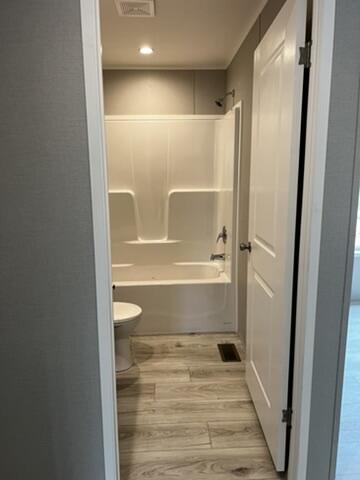 132 Spruce St, Greentown, PA 18426 - full bathroom with wood finished floors, toilet, and tub / shower combination
