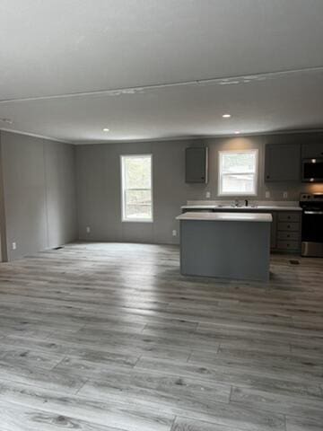 132 Spruce St, Greentown, PA 18426 - kitchen featuring stainless steel microwave, stove, open floor plan, wood finished floors, and recessed lighting