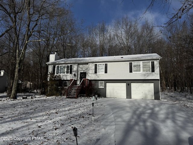 split foyer home with a garage and a chimney