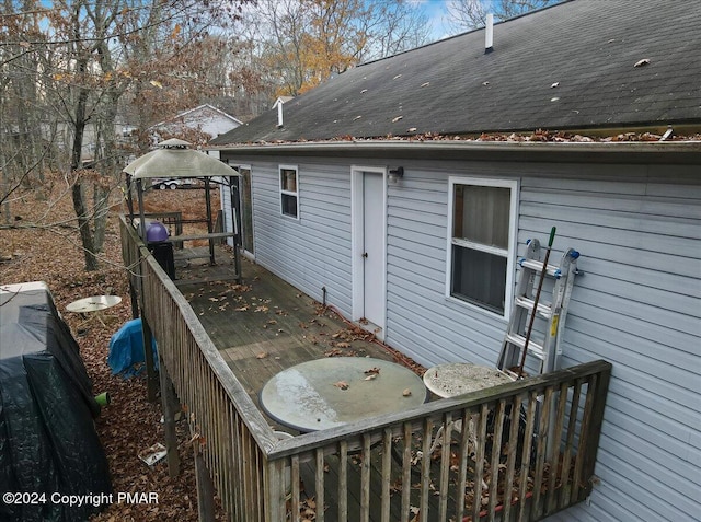 view of property exterior featuring a gazebo and a wooden deck