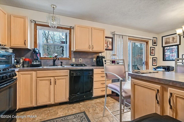 kitchen featuring black appliances, light brown cabinets, a sink, and a textured ceiling