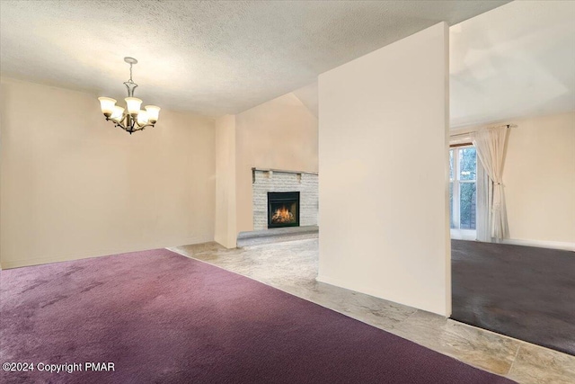 unfurnished living room featuring vaulted ceiling, a textured ceiling, a fireplace, and carpet flooring