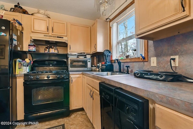 kitchen featuring a toaster, under cabinet range hood, black appliances, light brown cabinets, and a sink